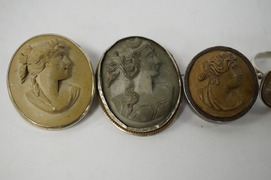 Three assorted carved cameo lava brooches, largest 32mm, together with a pair of similar earrings and a 930s and cameo lava ring. Condition - poor to fair